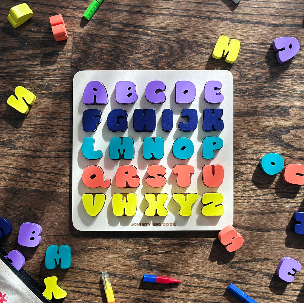Colorful alphabet magnets on a wooden surface